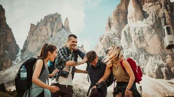 Group of people traveling mountains together