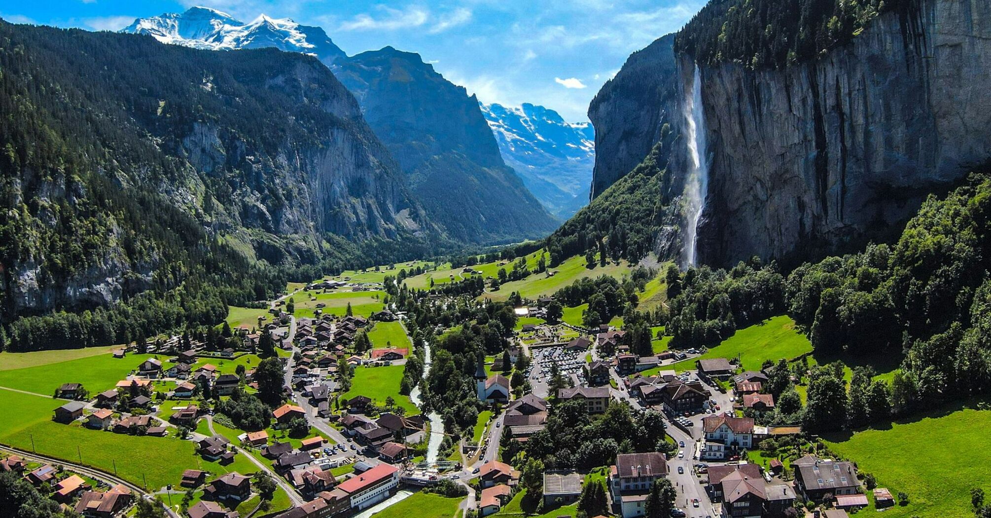 Picturesque view of Lauterbrunnen valley with Staubbach Falls and surrounding mountains