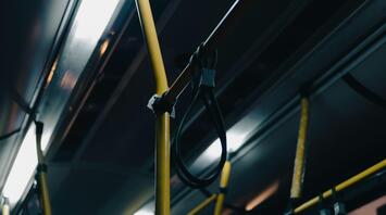 Interior of a bus with yellow handrails and loops
