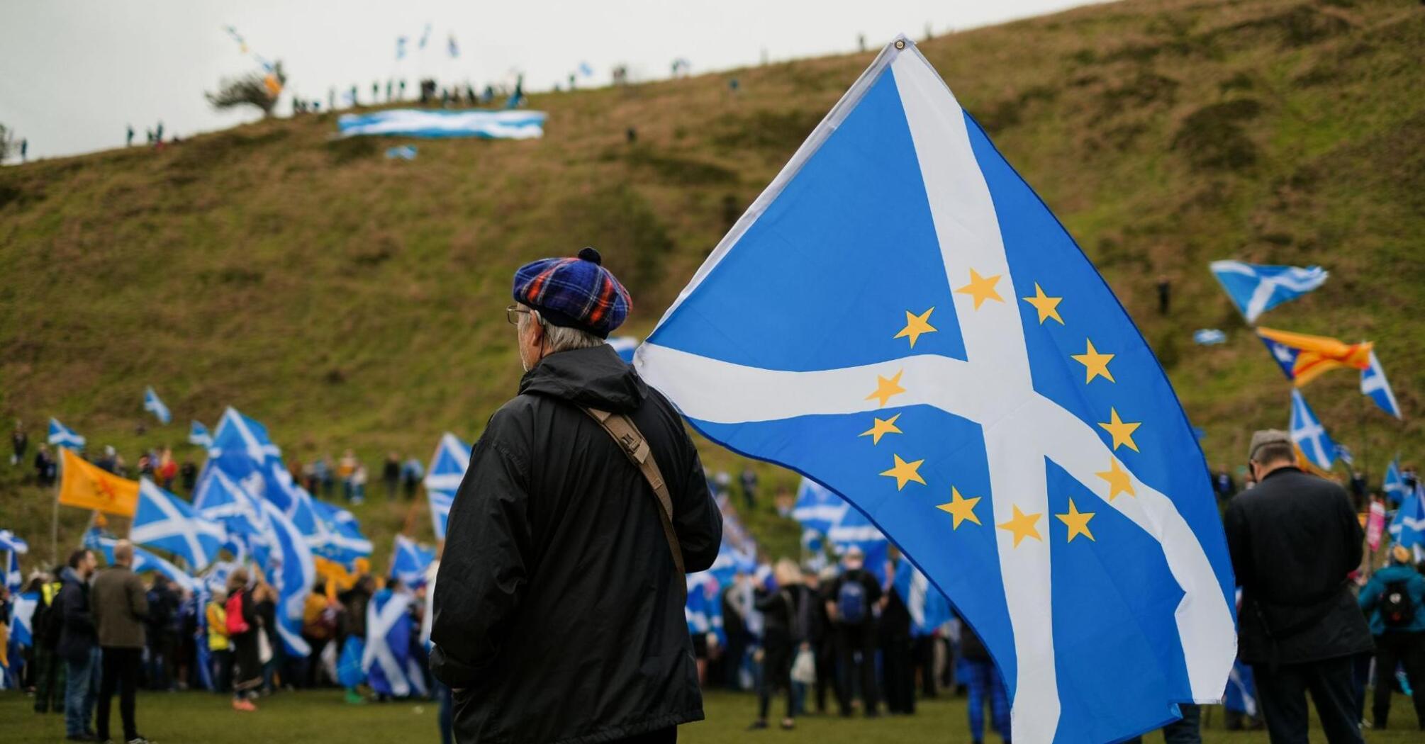 Man holding the Scotland and European Union flag