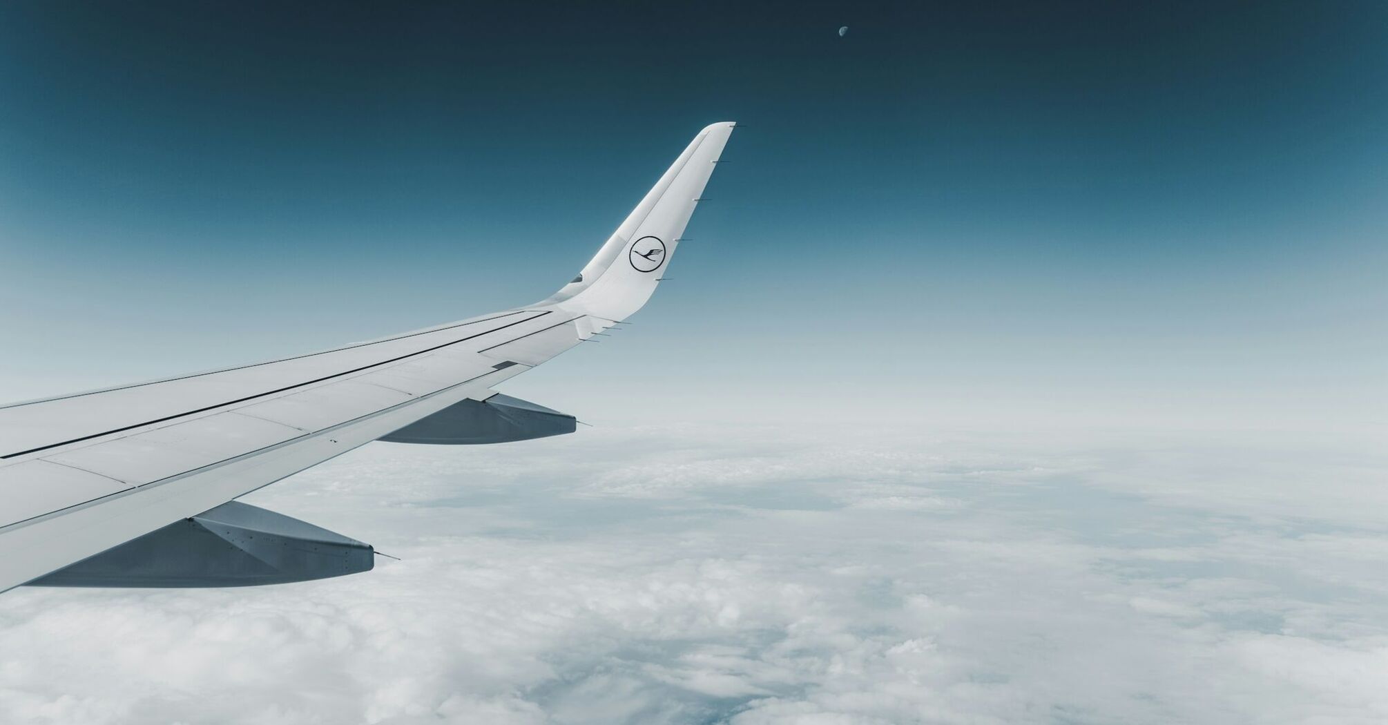 Lufthansa airplane wing above the clouds