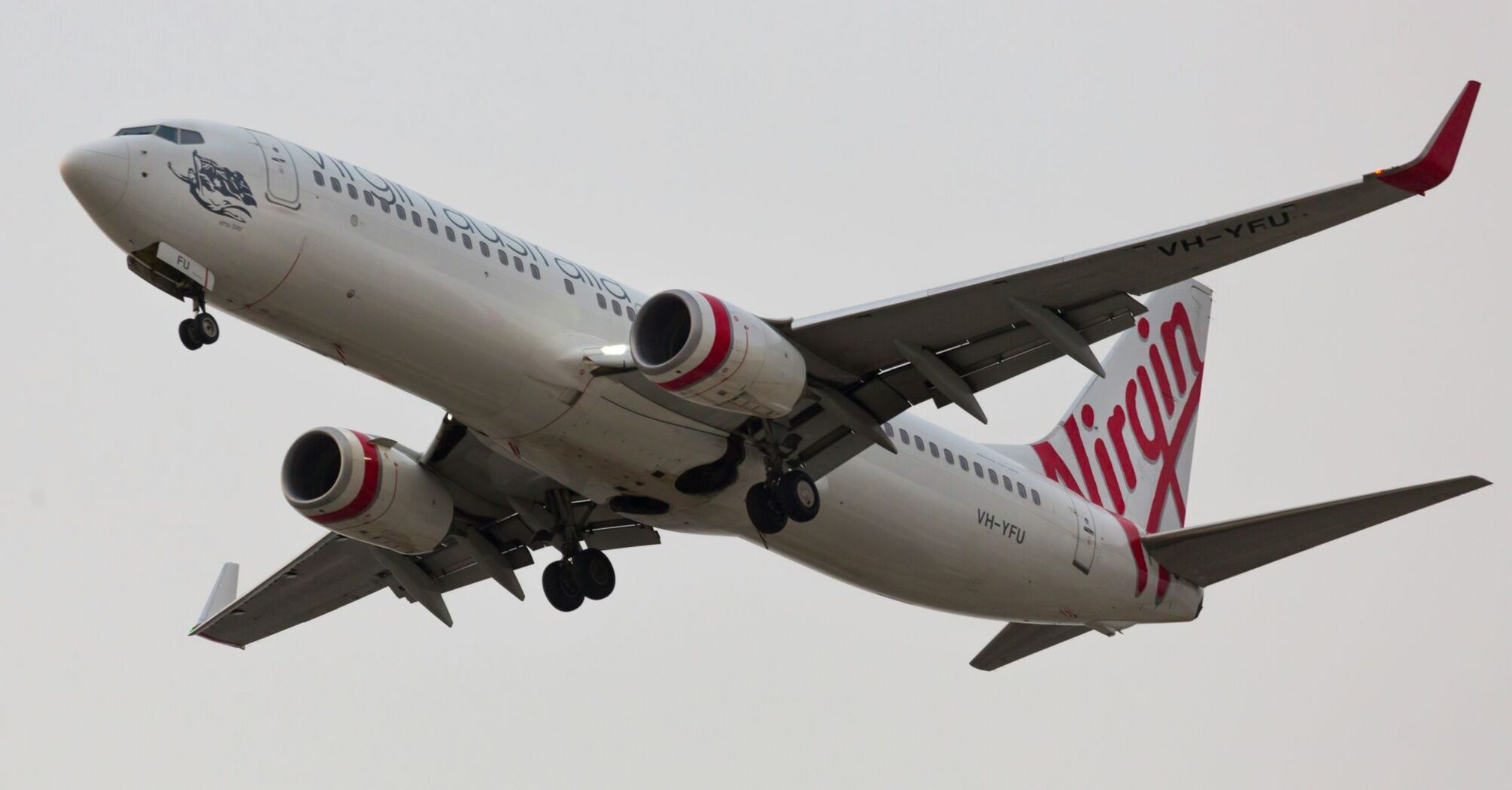 white and red Virgin Australia airplane in mid air during daytime