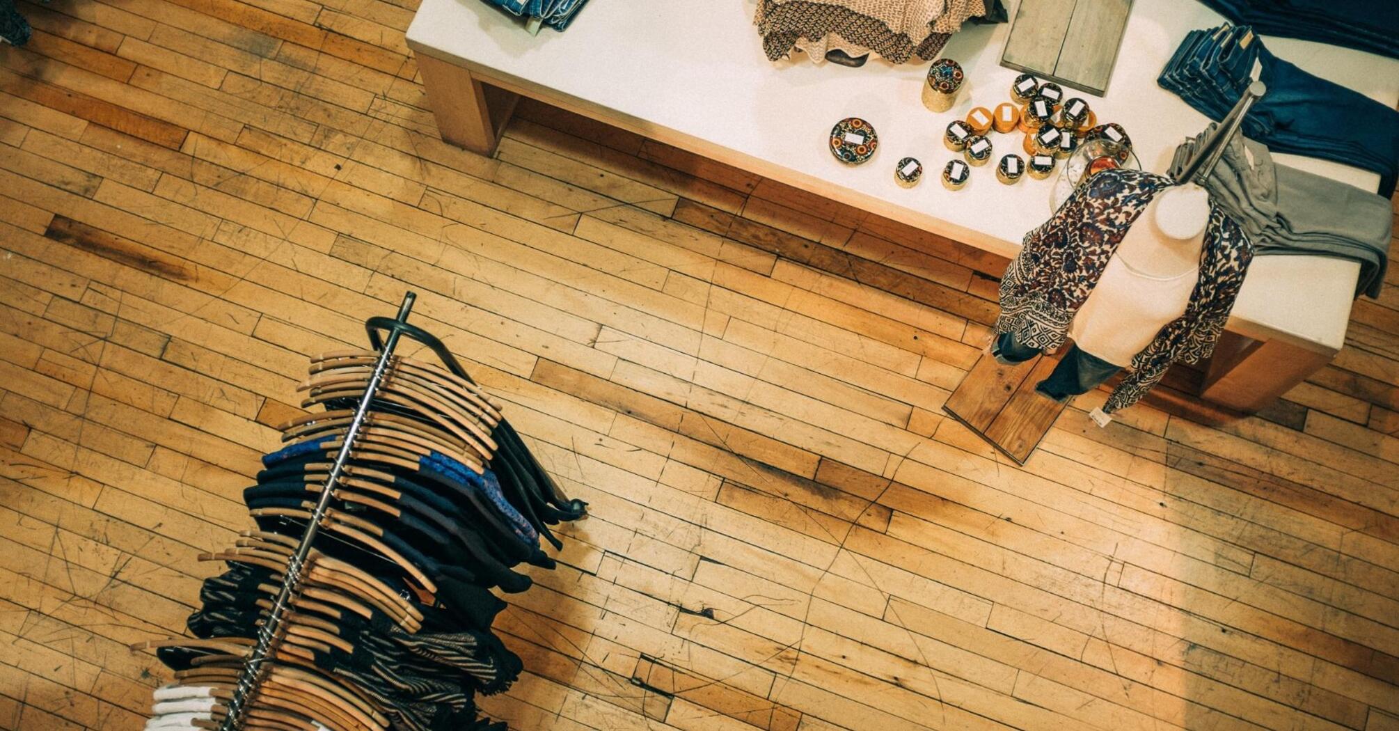 Aerial view of a boutique with clothes displayed on racks and a table