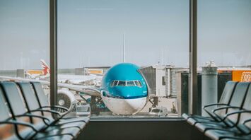 KLM airplane parked near passenger pathway