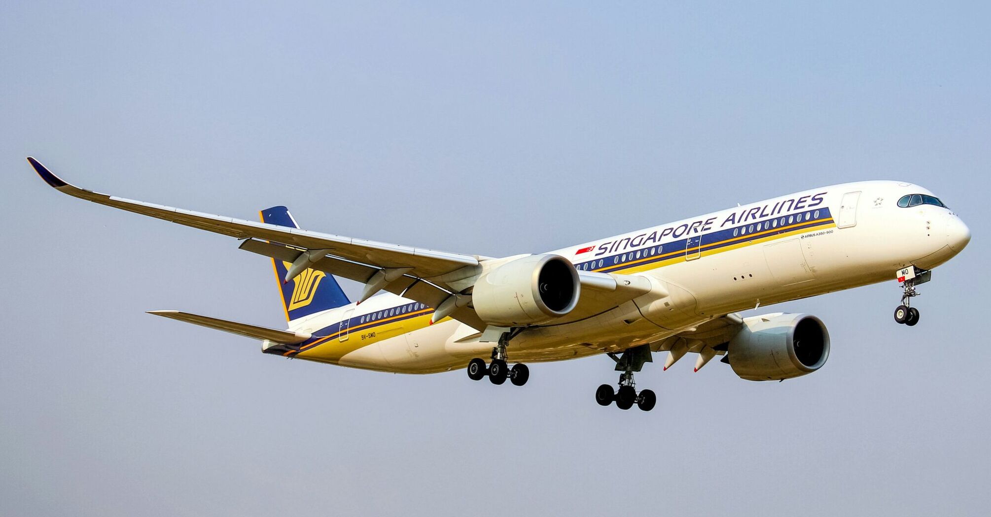 white and blue Singapore Airlines passenger plane in mid air during daytime