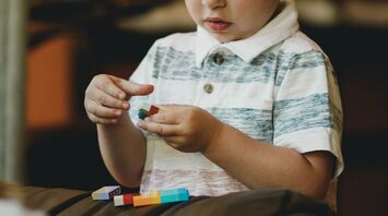 Young child playing with colorful building blocks