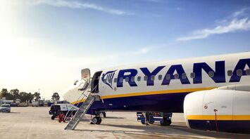 Ryanair aircraft parked at an airport with open boarding stairs