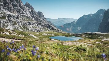 Lake surrounded by rocky mountains at daytime