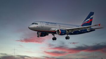 White and blue passenger plane in flight