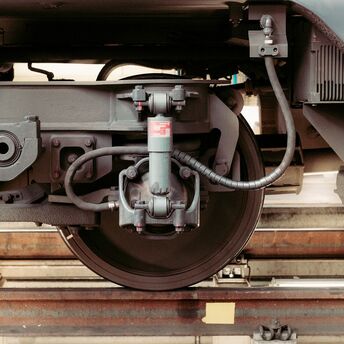Close-up of train wheel assembly on tracks
