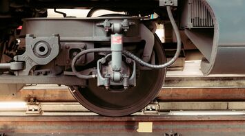 Close-up of train wheel assembly on tracks