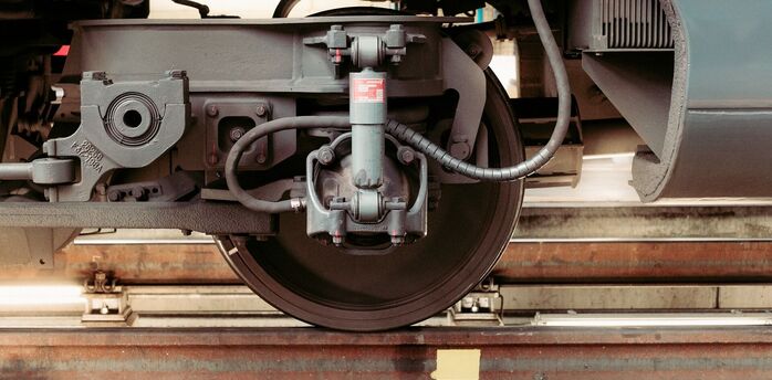 Close-up of train wheel assembly on tracks