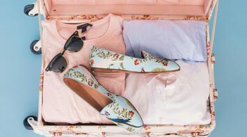 Vacation outfit items in luggage