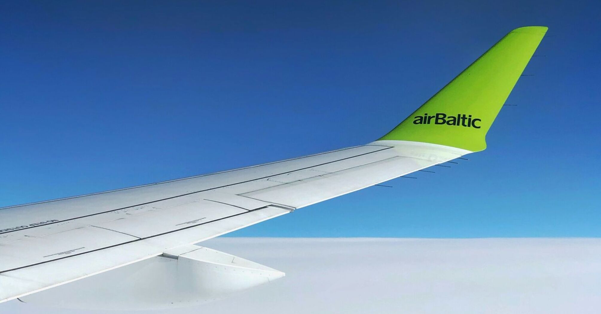 white and green airBaltic airplane wing