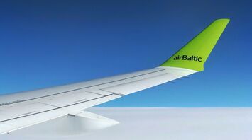 white and green airBaltic airplane wing