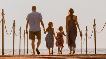 Family walk on the beach holding hands