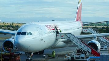 Iberia airplane at an airport gate