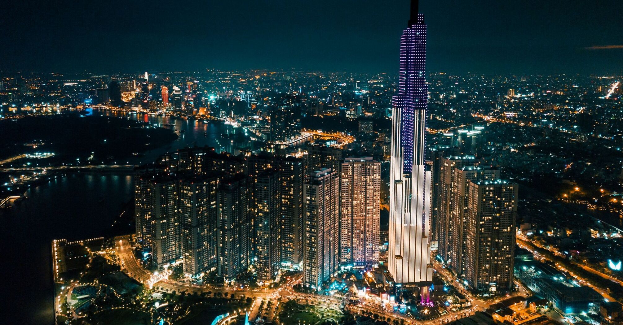 Ho Chi Minh City at night with illuminated skyscrapers and city lights