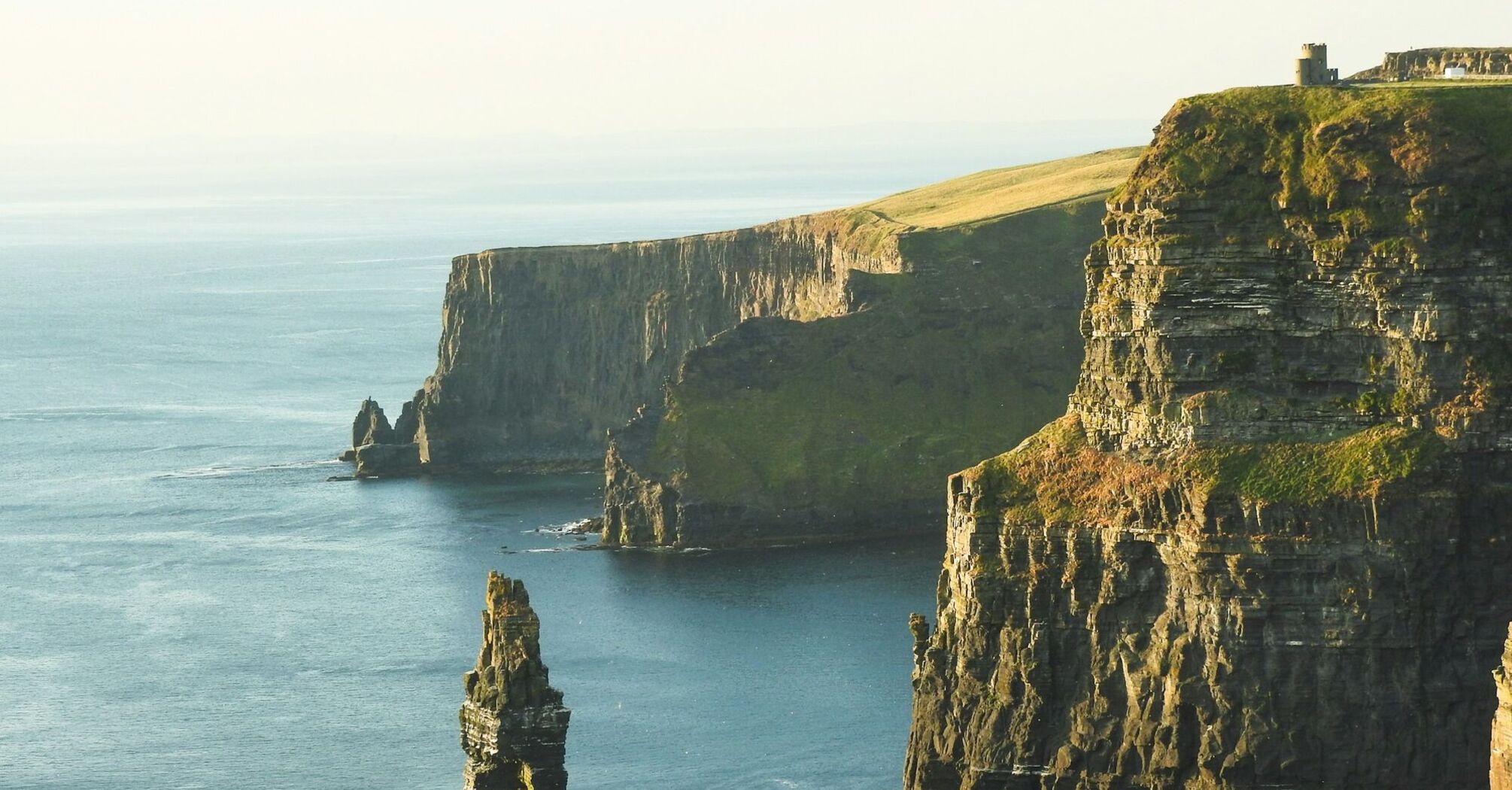 Sunlit Cliffs of Moher, Ireland, overlooking the Atlantic