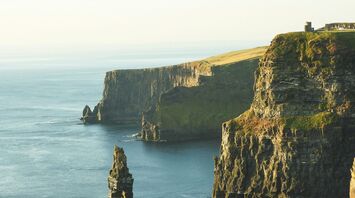 Sunlit Cliffs of Moher, Ireland, overlooking the Atlantic