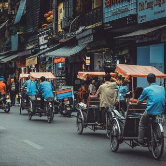 Man driving white motor scooter on road