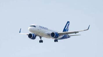 A large jetliner flying through a blue sky