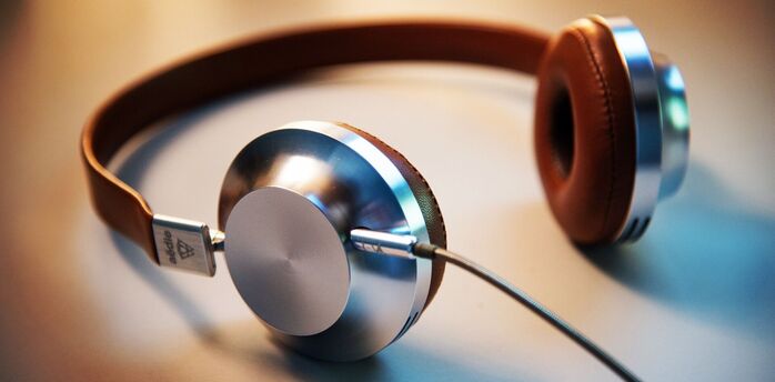 Stylish headphones with brown leather accents and metallic ear cup