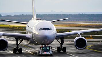 White and blue airplane on airport during daytime