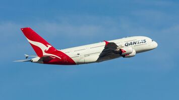 White and red air plane in mid air during daytime