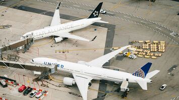 White and blue airplane on airport during daytime