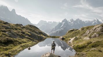 Person standing on rock mountain during daytime