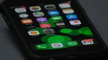 Close-up of a smartphone screen displaying various apps including Airbnb
