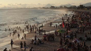 The beach is crowded with people