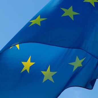 European Union flag waving against a clear blue sky
