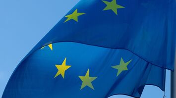 European Union flag waving against a clear blue sky