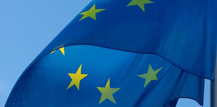European Union flag waving against a clear blue sky
