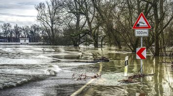 Flooded roadway with warning signs