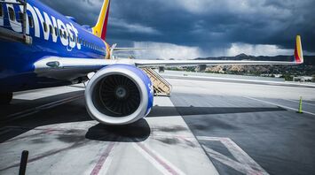 Southwest Airlines jet parked on tarmac under stormy skies