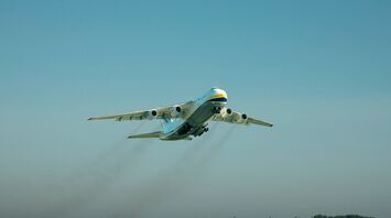 An airplane flying over a runway