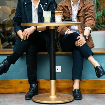 Couple with two coffees sitting at a table