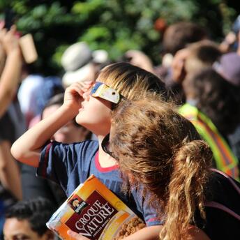 Children look at the solar eclipse