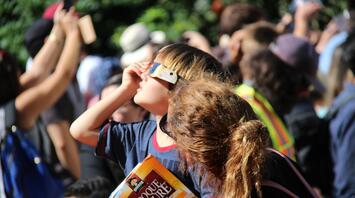 Children look at the solar eclipse