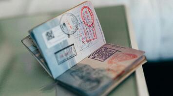 An unfolded visa lies on the table