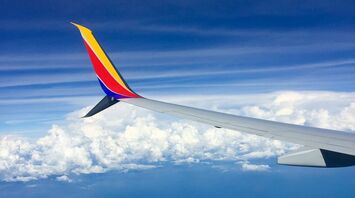 View from a plane window showing the wing of a Southwest Airlines
