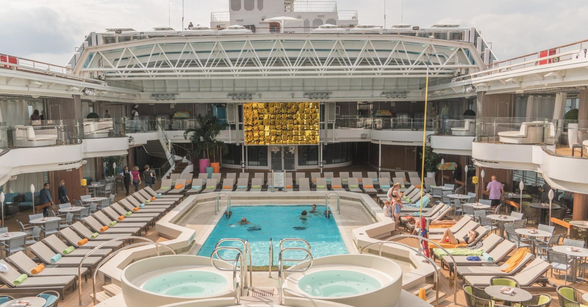 Swimming pool on the territory of a cruise ship surrounded by sun loungers