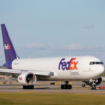 White and purple passenger plane on airport during daytime