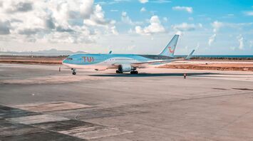white and blue airplane on airport during daytime