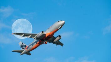 low angle photography of gray and red jet passenger plane