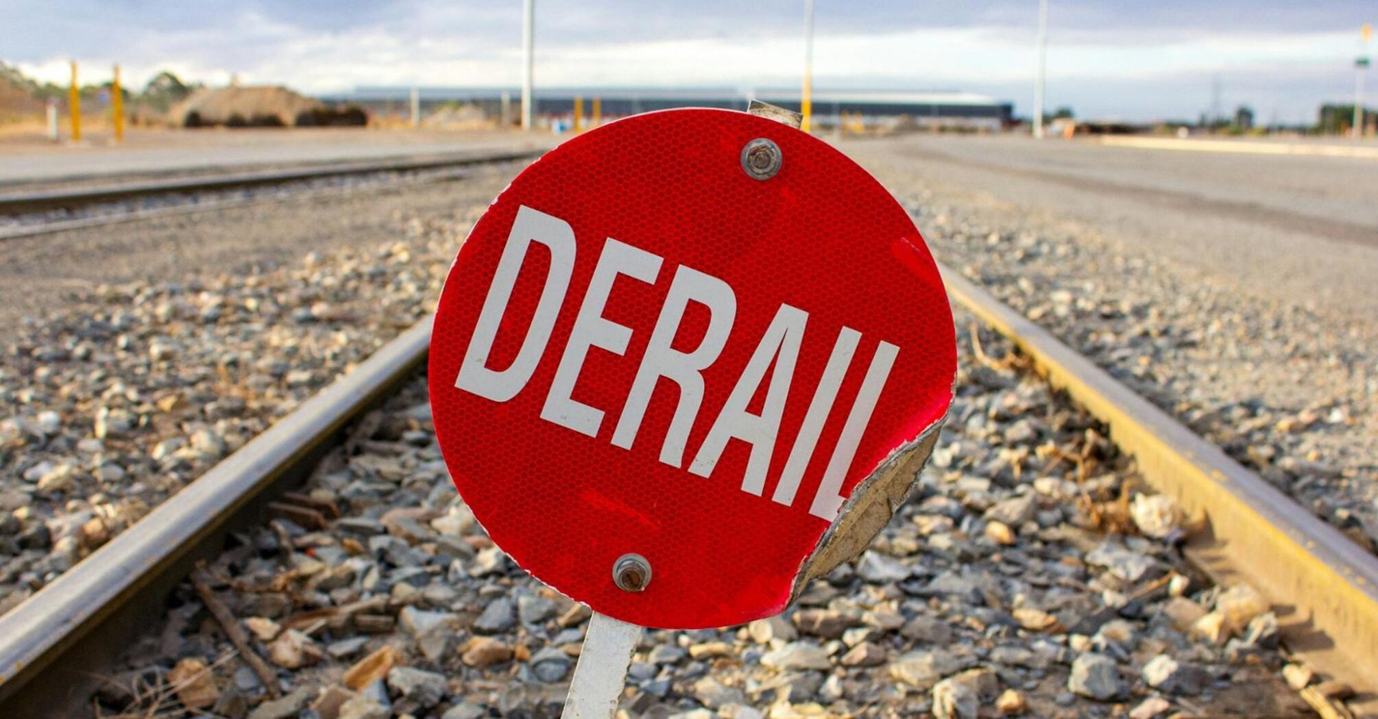 Red sign with the word 'Derail' on railway tracks