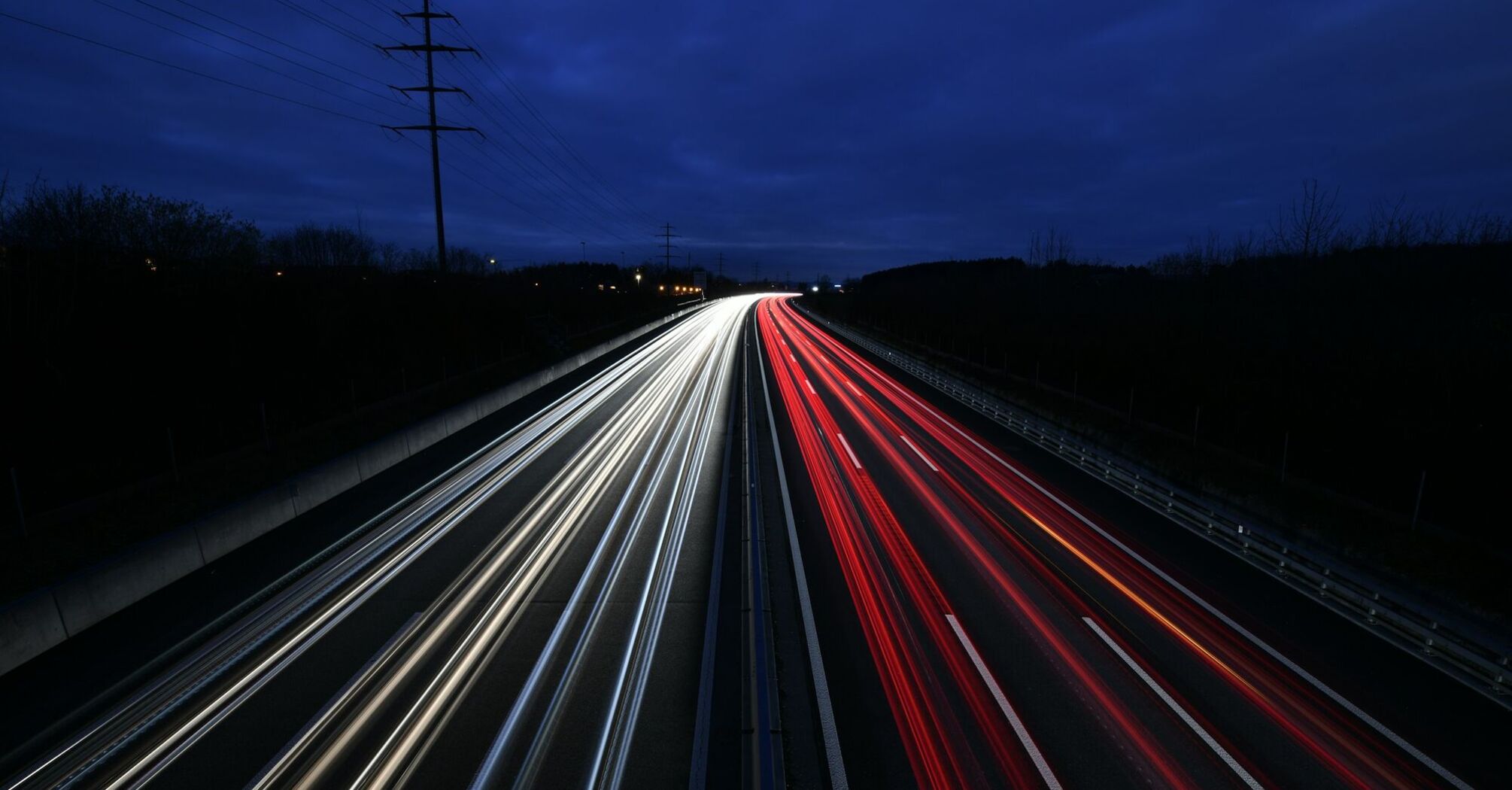 Nighttime traffic on a highway with light trails
